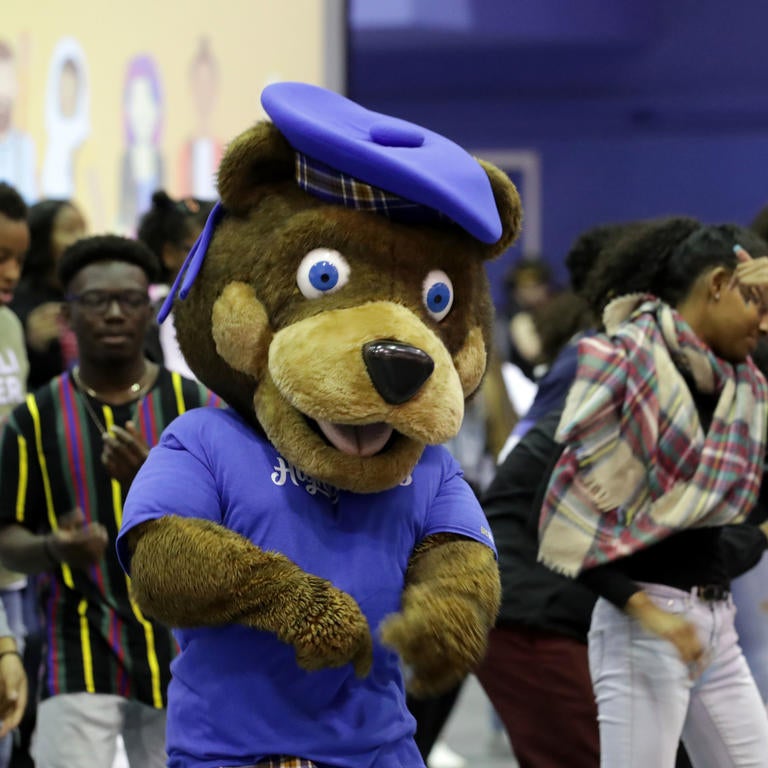 Scotty Highlander Mascot dancing with students on signing day