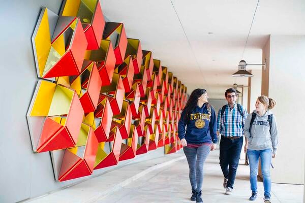 Students walking by the Genomics building